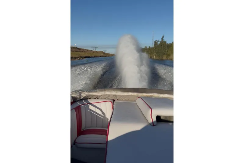 Slide: The Image of 1975 Sleekcraft Executive 23 boat cruising on a sunny waterway. - 9