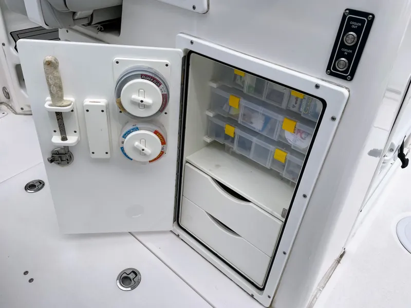 Slide: The Image of 2019 Sea Fox 328 Commender storage compartment with switches and drawers. - 40