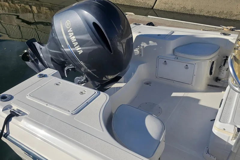 Slide: The Image of 2002 Sea Fox 210 Center Console boat with Yamaha outboard motor, docked in sunlight. - 10