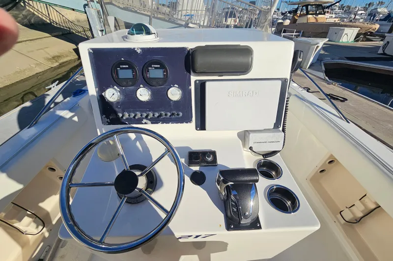 Slide: The Image of 2002 Sea Fox 210 Center Console boat dashboard with steering wheel and navigation instruments. - 5