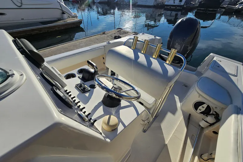 Slide: The Image of 2002 Sea Fox 210 Center Console boat interior with steering wheel and controls. - 6