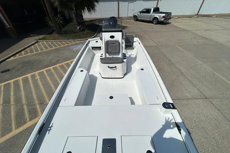 Slide: The Image of Avid 21 Recon 2026 boat in parking lot, showcasing spacious deck and seating. - 14