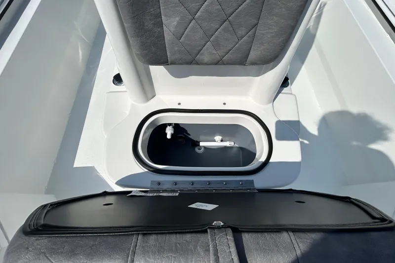 Slide: The Image of Interior view of 2026 Avid 21 Recon boat, featuring storage compartment and seating. - 15