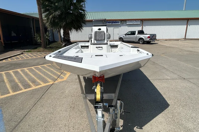 Slide: The Image of 2026 Avid 21 Recon boat on trailer in parking lot, front view. - 2