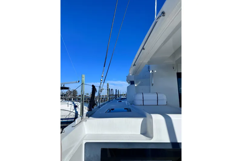 Slide: The Image of 2023 Lagoon 50 yacht docked under clear blue sky. - 15