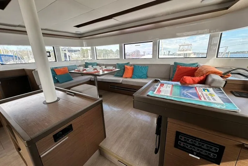 Slide: The Image of Luxurious interior of 2023 Lagoon 50 yacht with colorful cushions and dining area. - 23