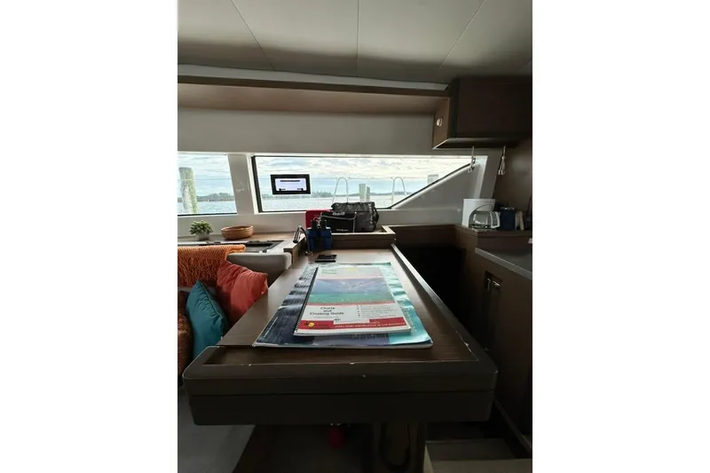 Slide: The Image of Interior of 2023 Lagoon 50 yacht with navigation table and sea view. - 26
