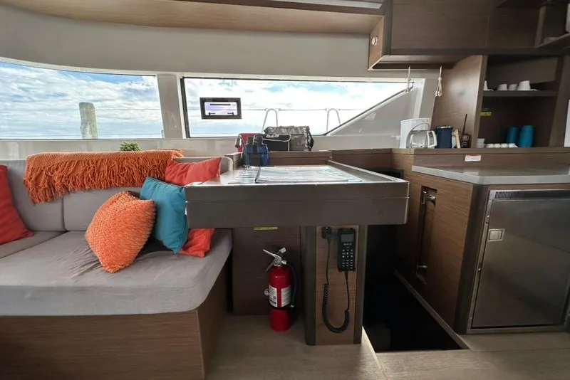 Slide: The Image of Interior of 2023 Lagoon 50 yacht with cozy seating and modern kitchen amenities. - 27
