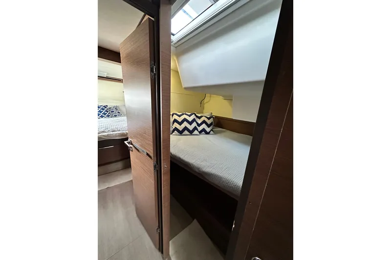 Slide: The Image of Interior of 2023 Lagoon 50 yacht, featuring cozy bed and pillow. - 28