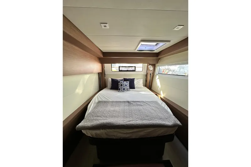 Slide: The Image of Luxurious cabin interior of 2023 Lagoon 50 yacht with cozy bedding and natural light. - 32
