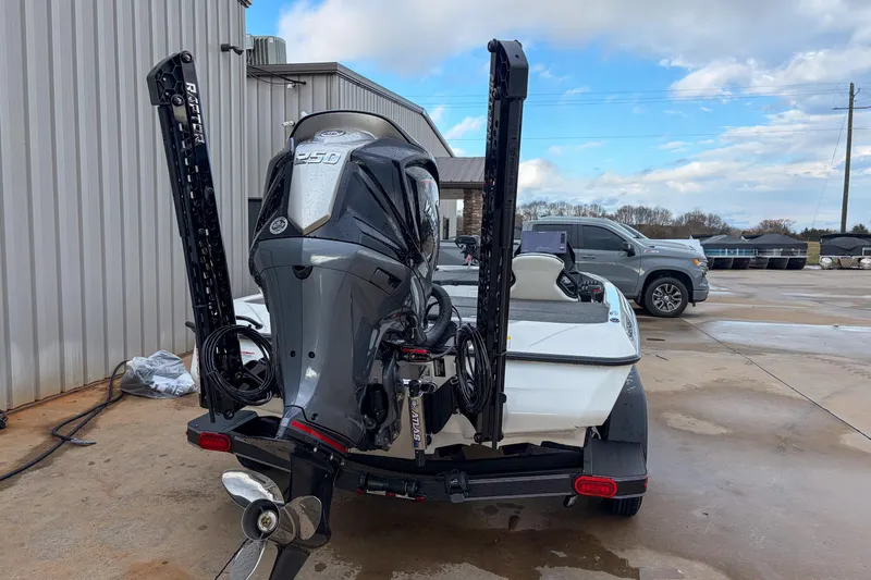 Slide: The Image of 2026 Skeeter ZXE21 boat with powerful outboard motor, parked outdoors on a concrete surface. - 10