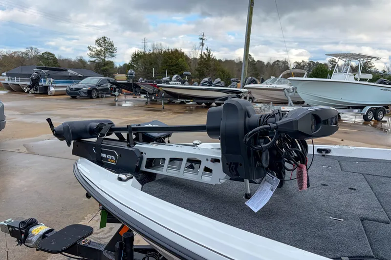 Slide: The Image of 2026 Skeeter ZXE21 boat with Minn Kota Ultrex motor in a marina setting. - 14