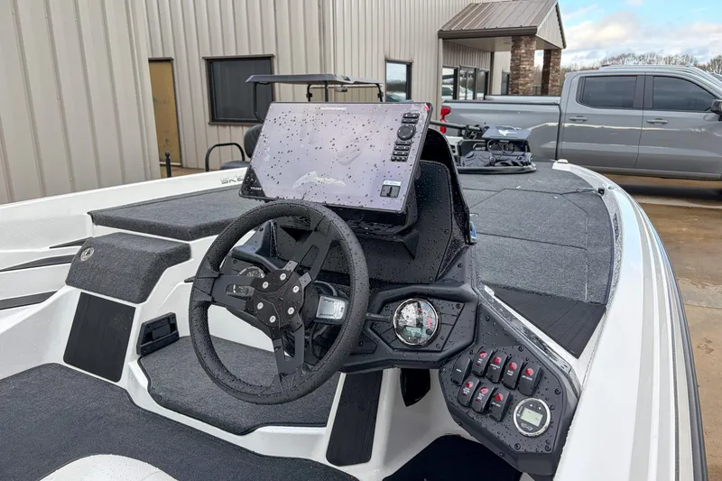 Slide: The Image of 2026 Skeeter ZXE21 boat dashboard with steering wheel and electronic controls. - 5