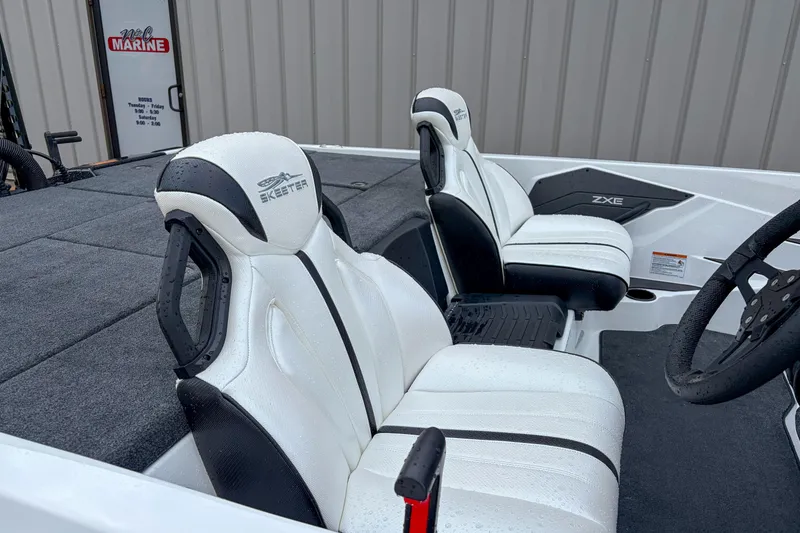 Slide: The Image of 2026 Skeeter ZXE21 boat interior with white and black seats, steering wheel visible. - 6