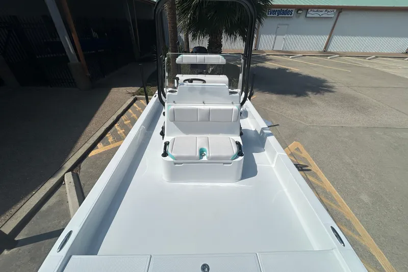 Slide: The Image of 2026 Shallow Sport 18 Sport boat with seating, parked in a lot. - 16