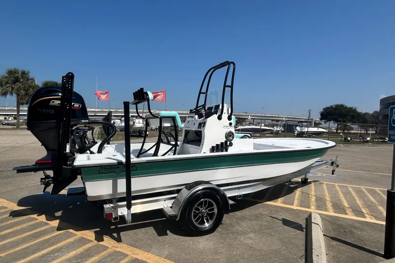 Slide: The Image of 2026 Shallow Sport 18 Sport boat on trailer in parking lot, sunny day. - 5