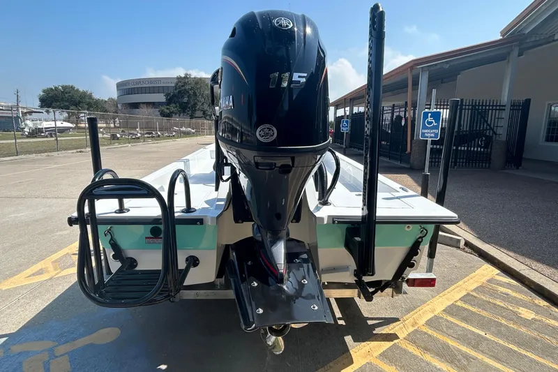 Slide: The Image of 2026 Shallow Sport 18 Sport boat with Yamaha 115 engine, parked in a lot. - 6