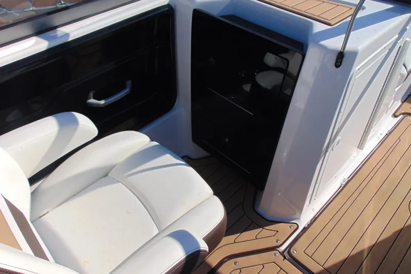 Slide: The Image of 2022 Yamaha Boats 212SE interior with white seating and teak-style flooring. - 11