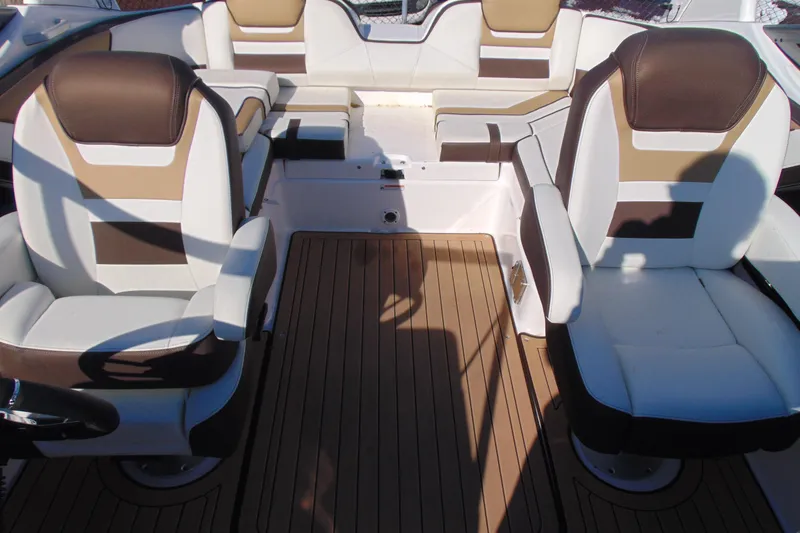 Slide: The Image of Interior of 2022 Yamaha Boats 212SE, featuring luxurious seating and wood-style flooring. - 14