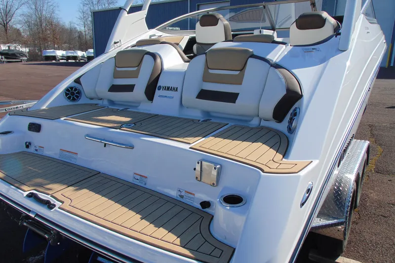 Slide: The Image of 2022 Yamaha Boats 212SE, rear view, showcasing seating and deck design. - 4