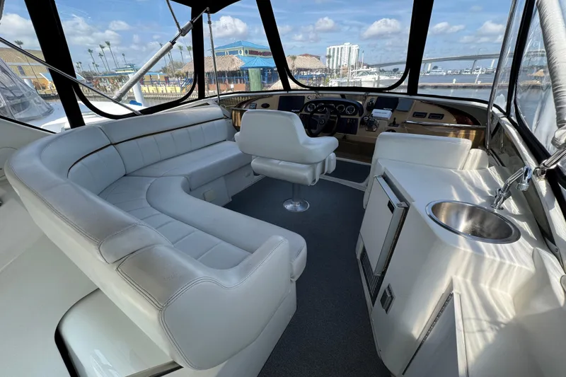 Slide: The Image of 2004 Carver 444 Cockpit Motor Yacht interior with white seating and helm. - 11