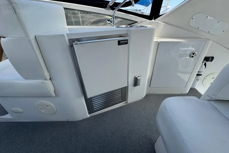 Slide: The Image of 2004 Carver 444 Cockpit Motor Yacht interior with sink and storage cabinets. - 16