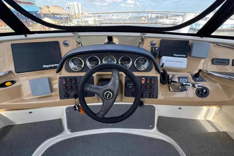 Slide: The Image of Cockpit view of 2004 Carver 444 Cockpit Motor Yacht with steering wheel and navigation instruments. - 17