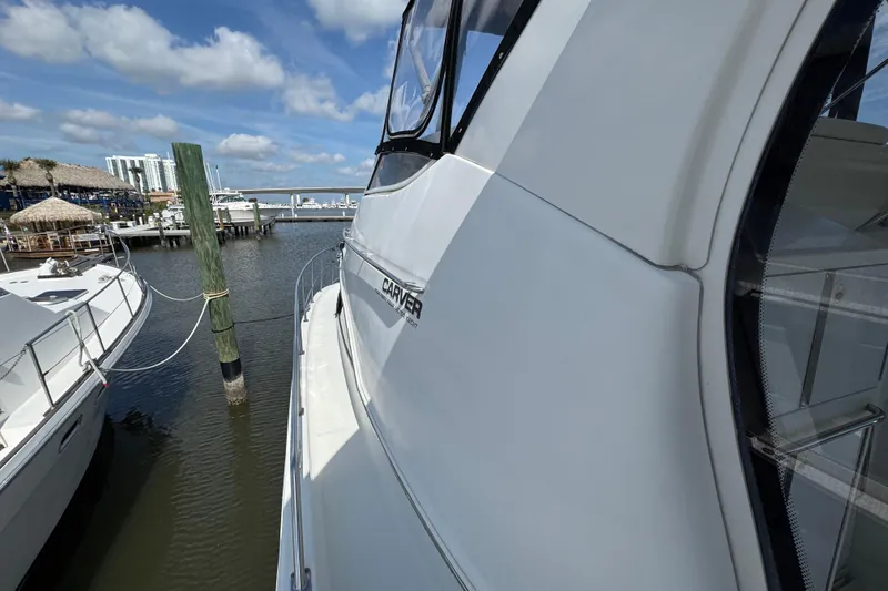 Slide: The Image of 2004 Carver 444 Cockpit Motor Yacht docked at marina under blue sky. - 22