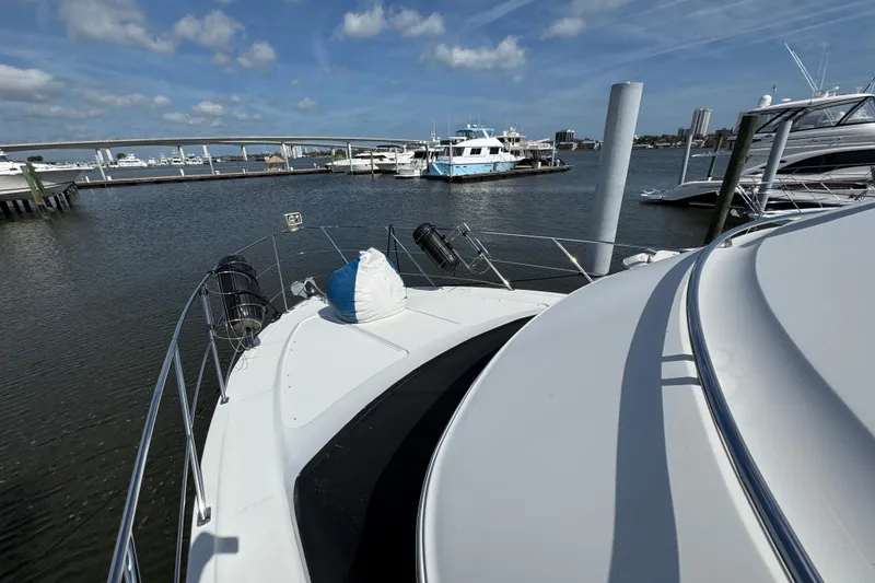 Slide: The Image of 2004 Carver 444 Cockpit Motor Yacht docked at marina under blue sky. - 23
