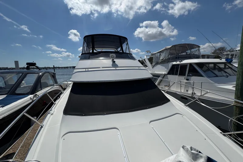 Slide: The Image of 2004 Carver 444 Cockpit Motor Yacht docked under a bright blue sky. - 24