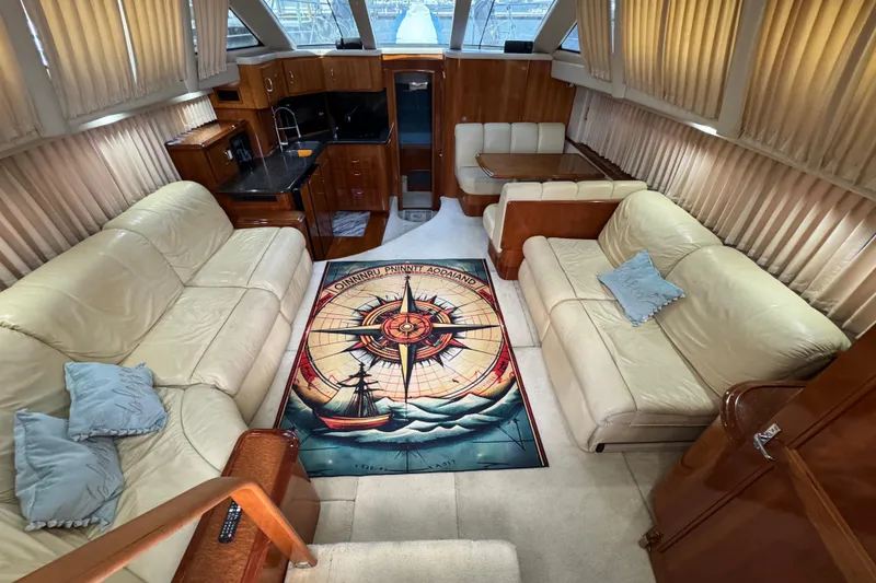 Slide: The Image of Luxurious interior of 2004 Carver 444 Cockpit Motor Yacht with plush seating and nautical decor. - 25