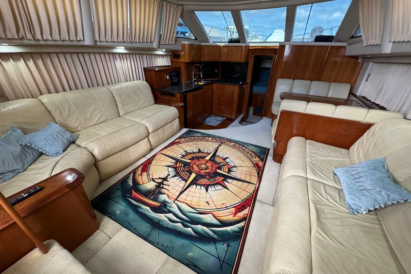 Slide: The Image of Luxurious interior of 2004 Carver 444 Cockpit Motor Yacht with plush seating and nautical-themed decor. - 26