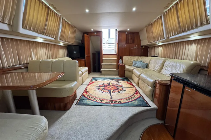 Slide: The Image of Luxurious interior of 2004 Carver 444 Cockpit Motor Yacht with plush seating and elegant decor. - 29