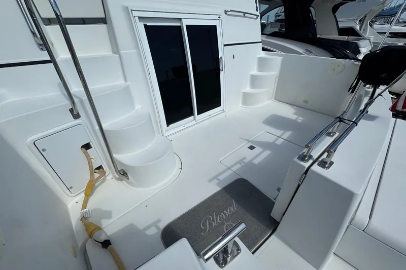 Slide: The Image of 2004 Carver 444 Cockpit Motor Yacht, white deck with steps and sliding door. - 3