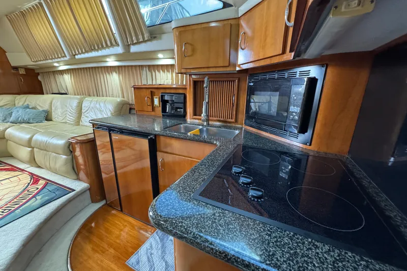 Slide: The Image of Luxurious interior of 2004 Carver 444 Cockpit Motor Yacht with modern kitchen amenities. - 30