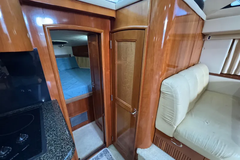 Slide: The Image of Interior of 2004 Carver 444 Cockpit Motor Yacht with wood finish and cozy seating. - 33