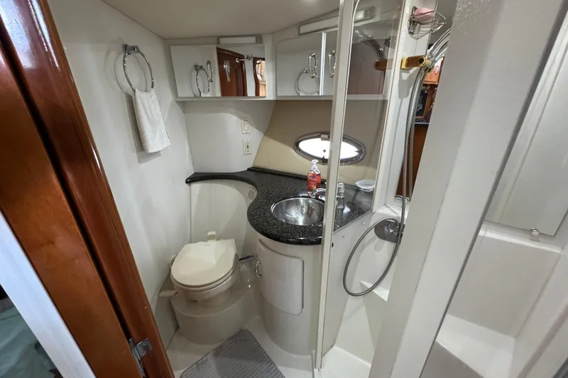 Slide: The Image of 2004 Carver 444 Cockpit Motor Yacht bathroom with sink, toilet, and shower. - 34