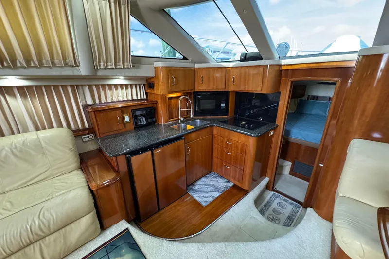 Slide: The Image of Luxurious interior of 2004 Carver 444 Cockpit Motor Yacht with modern kitchen and cozy seating. - 35