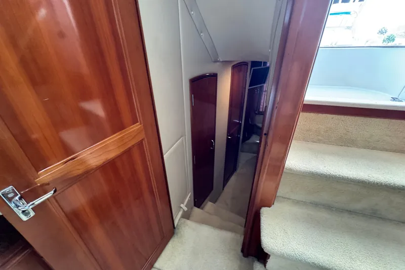 Slide: The Image of Interior view of 2004 Carver 444 Cockpit Motor Yacht, featuring wooden doors and carpeted stairs. - 36