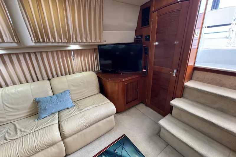 Slide: The Image of Interior of 2004 Carver 444 Cockpit Motor Yacht with beige sofa, TV, and stairs. - 37