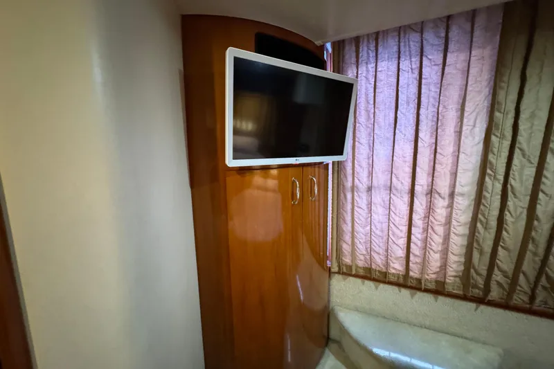 Slide: The Image of Interior of 2004 Carver 444 Cockpit Motor Yacht with TV and wooden cabinetry. - 39