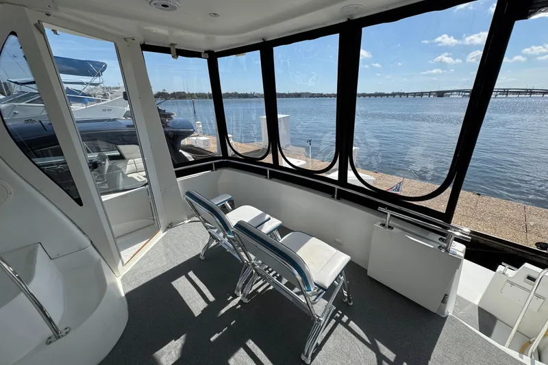 Slide: The Image of 2004 Carver 444 Cockpit Motor Yacht interior with waterfront view and seating area. - 7