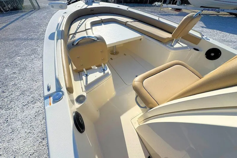 Slide: The Image of 2016 Scout 251 XS boat interior with beige seating and table, showcasing spacious design. - 12