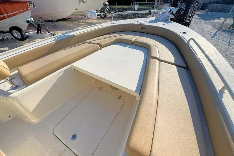 Slide: The Image of 2016 Scout 251 XS boat interior with cushioned seating and storage compartment. - 13