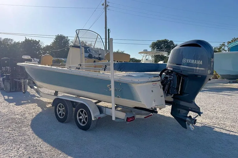 Slide: The Image of 2016 Scout 251 XS boat with Yamaha engine on trailer in sunny outdoor setting. - 3
