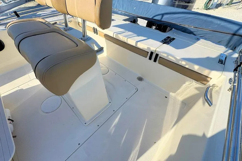 Slide: The Image of 2016 Scout 251 XS boat interior with beige seating and storage compartments. - 6
