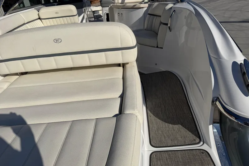 Slide: The Image of 2019 Cobalt R35 boat interior with white cushioned seating and gray flooring. - 15