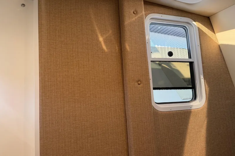 Slide: The Image of Interior view of a 2019 Cobalt R35 with a window and beige wall paneling. - 25