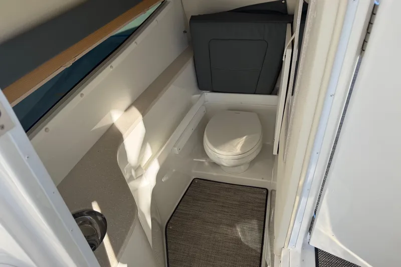 Slide: The Image of 2019 Cobalt R35 boat interior bathroom with toilet and sink. - 28
