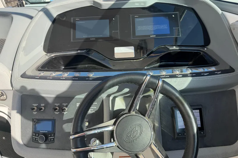 Slide: The Image of Dashboard of a 2019 Cobalt R35 boat with steering wheel and control panels. - 35